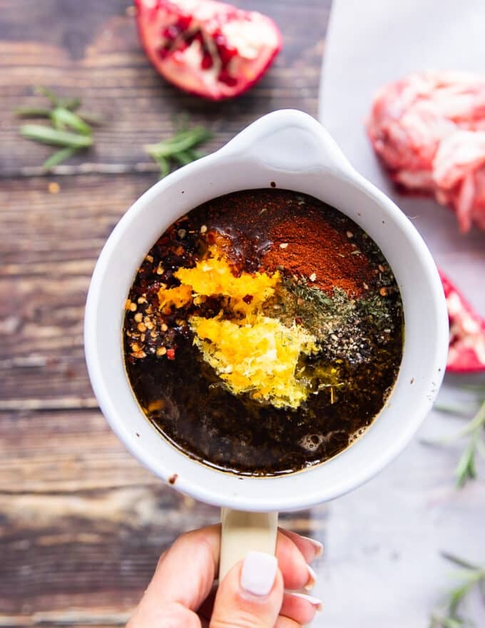 The balsalmic sauce is mixed in a bowl with citrus zests, olive oil and seasoning 