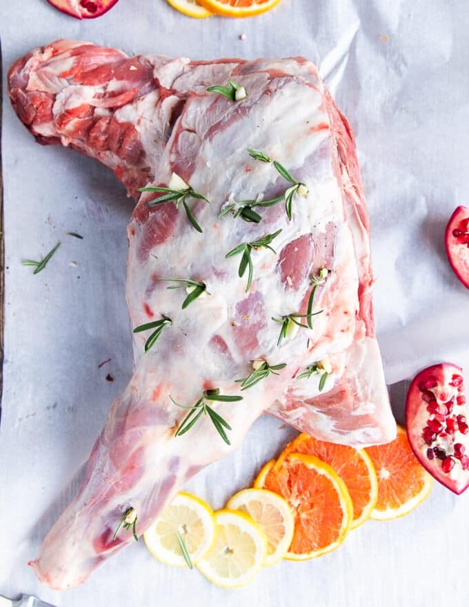 Fresh rosemary and garlic cloves inserted in the incisions along the lamb shoulder. 