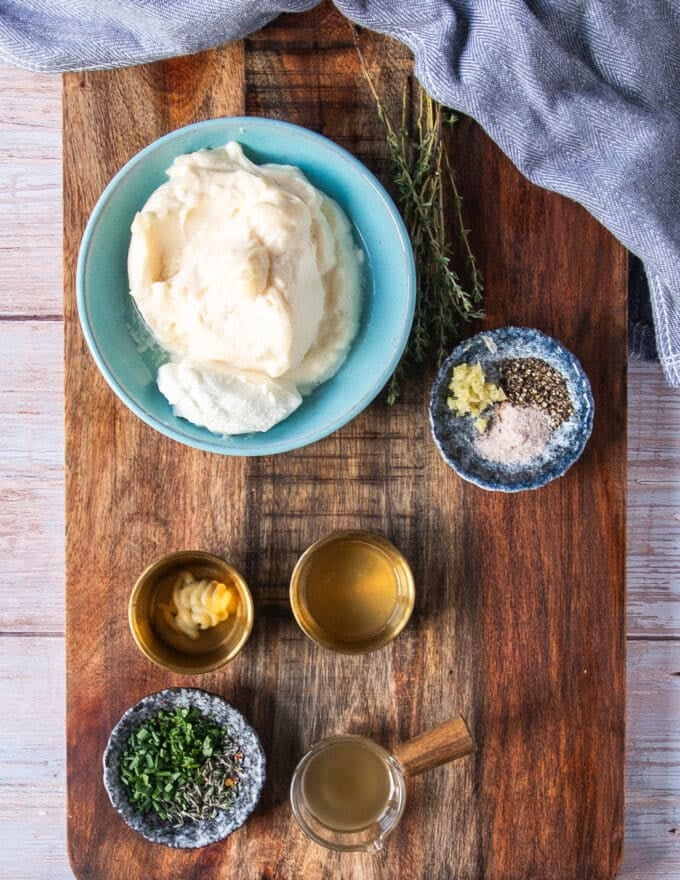 Ingredients needed for making truffle aioli at home including mayonnaise, garlic, truffle oil, mustard and lemon juice and herbs 