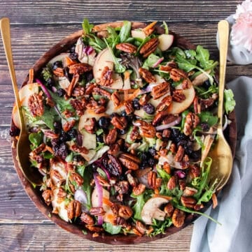 apple salad with greens apples maple vinaigrette and maple pecans in a bowl