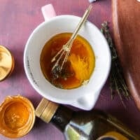salad dressing are added to a small bowl to whisk