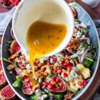 salad dressing is poured over the salad