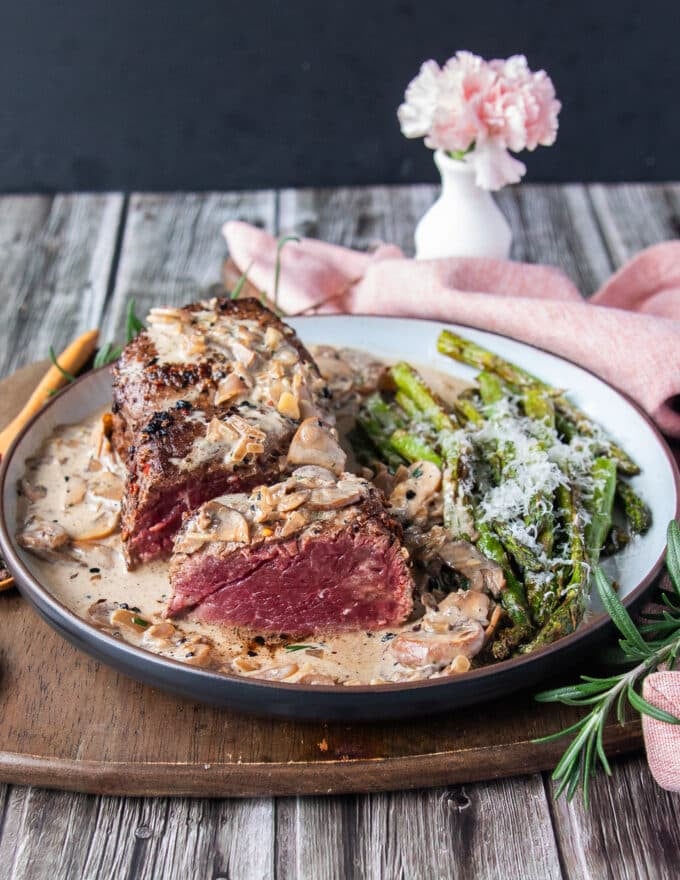 sliced medium rare cooked filet mignon showing how perfect cooked the steak is 