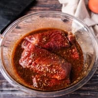 The flank steak is added to marinade bowl and ready to marinade.