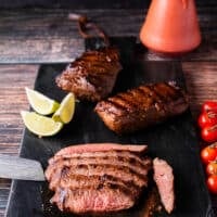 Flank steak is being sliced against the grain for a super tender cut