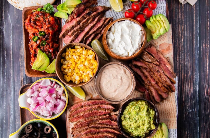 Flank Steak tacos all laid out in a taco board to allow each person to assemble their own