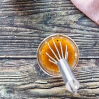 maple vinaigrette ingredients combined in a jar and whisk is used to emulsify