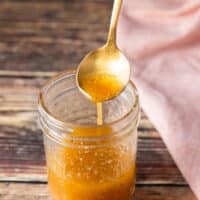 A spoon drizzling a maple vinaigrette showing consistency