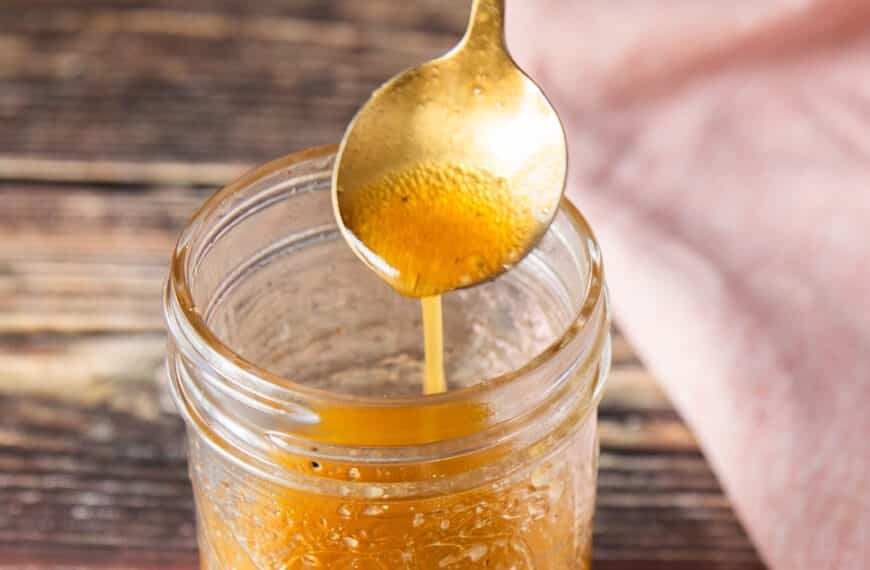 A spoon drizzling a maple vinaigrette showing consistency