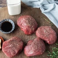 Seasoned filet mignon with salt and pepper ready to sear
