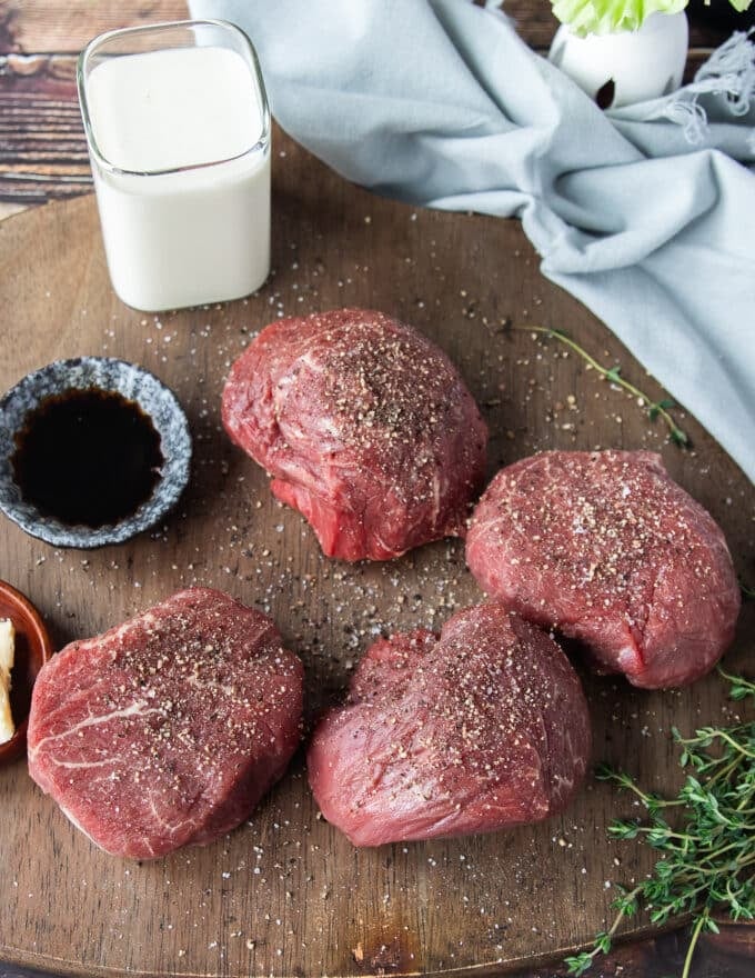 Seasoned filet mignon with salt and pepper ready to sear 
