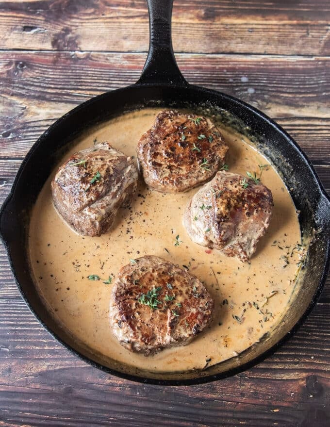 Cream is added after the sauce has simmered and reduced for the final creamy finish of the peppercorn steak sauce 