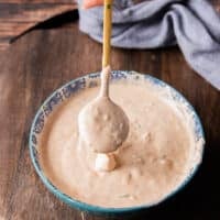 dripping taco sauce from a spoon onto a plate showing the texture