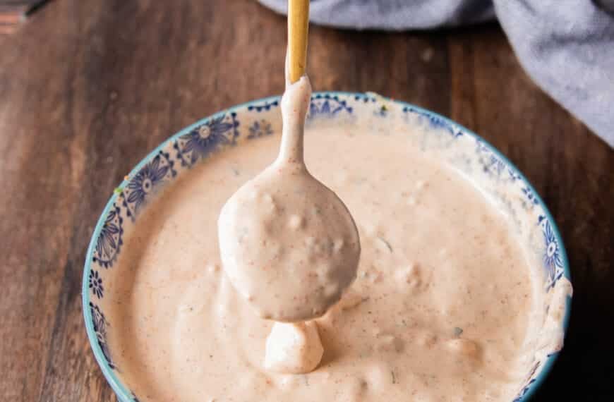 dripping taco sauce from a spoon onto a plate showing the texture