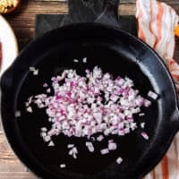 onions cooking in a hot skillet to prepare the beef mixture