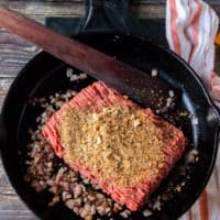 Meat is added with seasoning and garlic to cook well