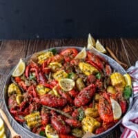 large platter of crawfish boil over newspaper