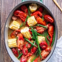 crawfish, corn and green beans are added to the pot