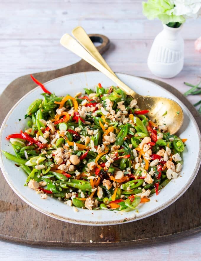 perfect snap pea salad all dressed up with crunchy nuts on top