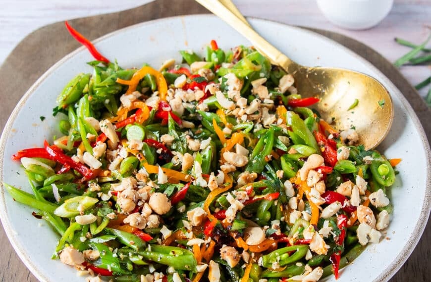 perfect snap pea salad all dressed up with crunchy nuts on top
