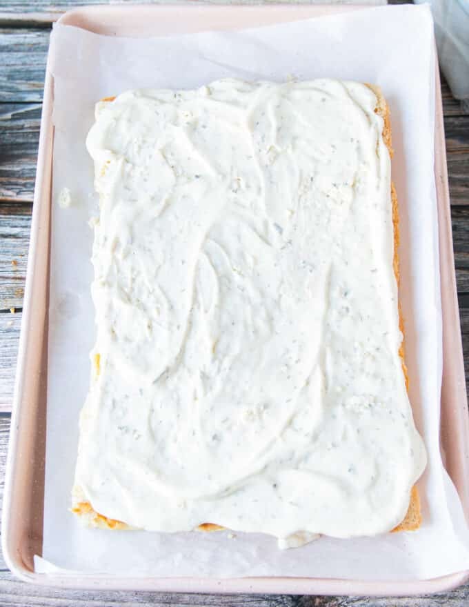 bottom of the slider bread spread with ranch to assemble chicken sliders 