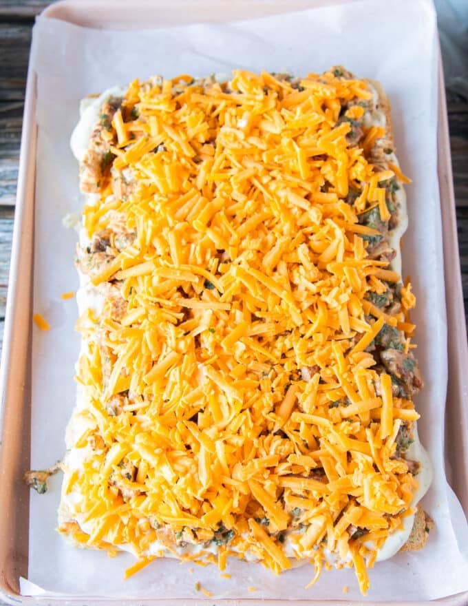 An extra layer of cheese is added over the chicken filling in the chicken sliders 