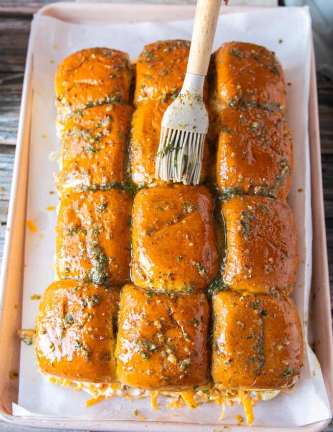 A brush used to brush the melted garlic herb butter over the tops of the slider bread evenly before baking 