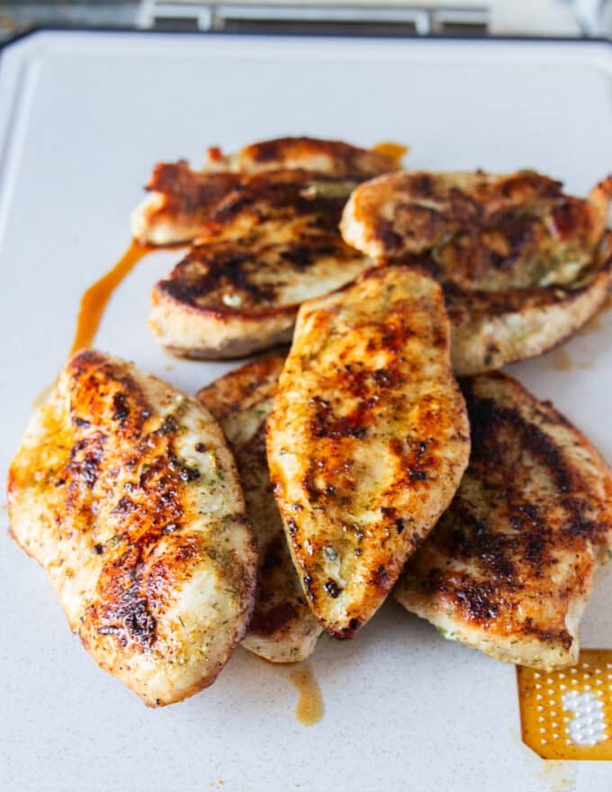 chicken cooked and removed on a to board to cool down