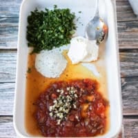 seasoning and herbs in a shallow plate ready to blend in with the chicken to flavor it up