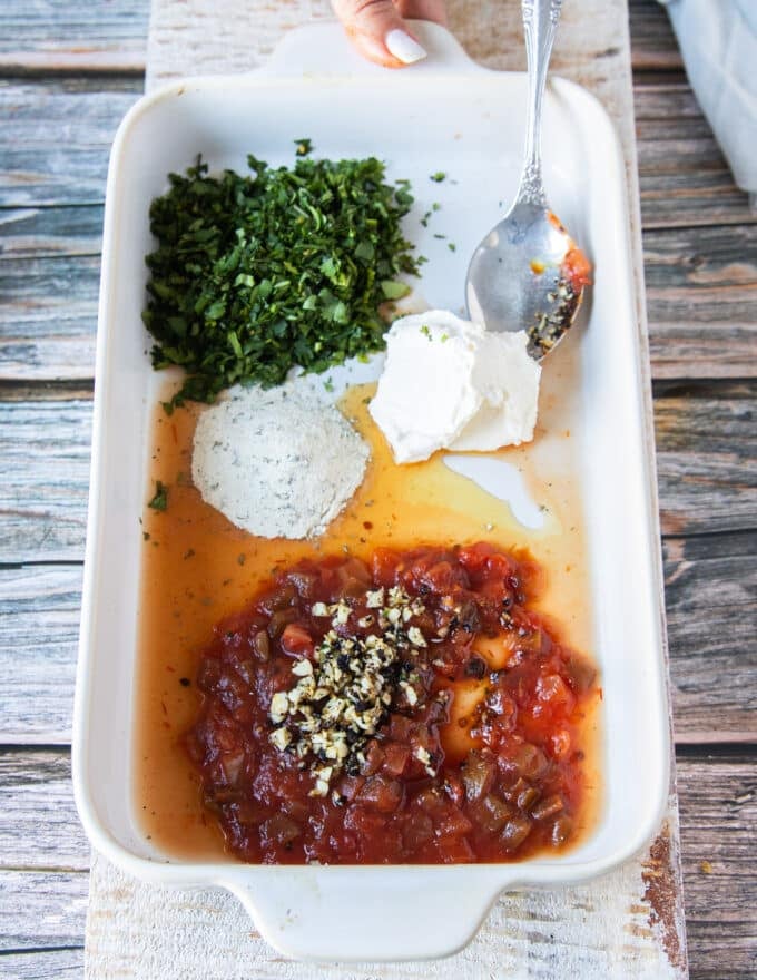 seasoning and herbs in a shallow plate ready to blend in with the chicken to flavor it up