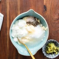 All ingredients of the coleslaw dressing added to a bowl and a whisk is used to blend it later