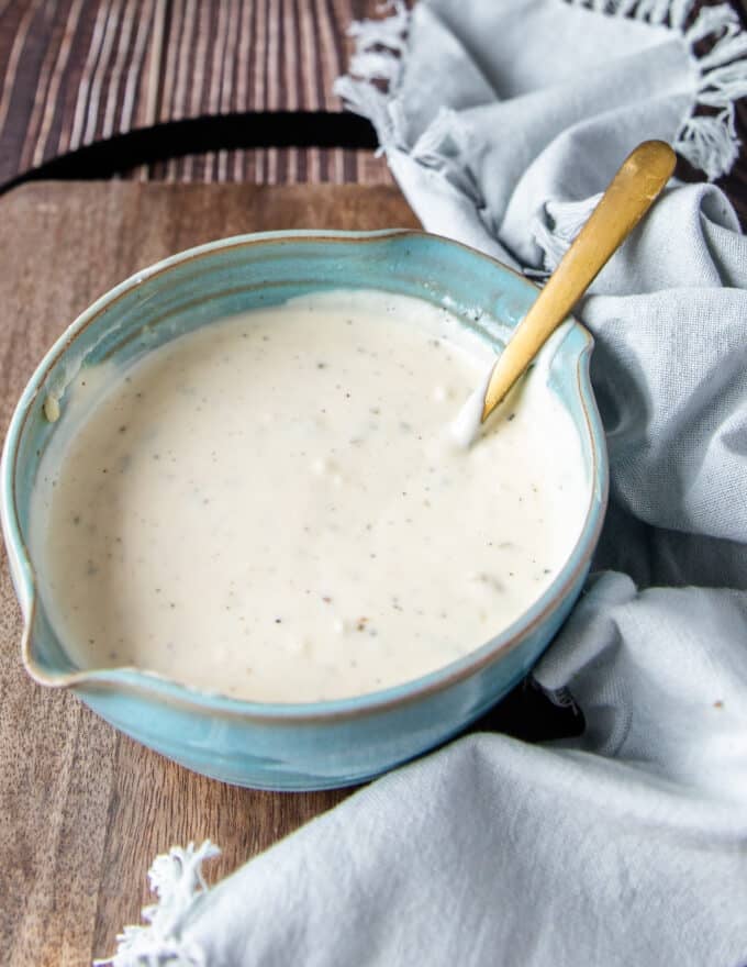 close up of a side view bowl filled with coleslaw dressing