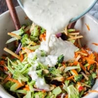 creamy coleslaw dressing added to a bowl of slaw
