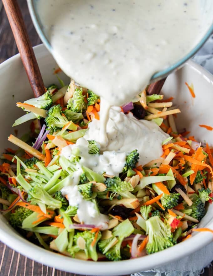 creamy coleslaw dressing added to a bowl of slaw