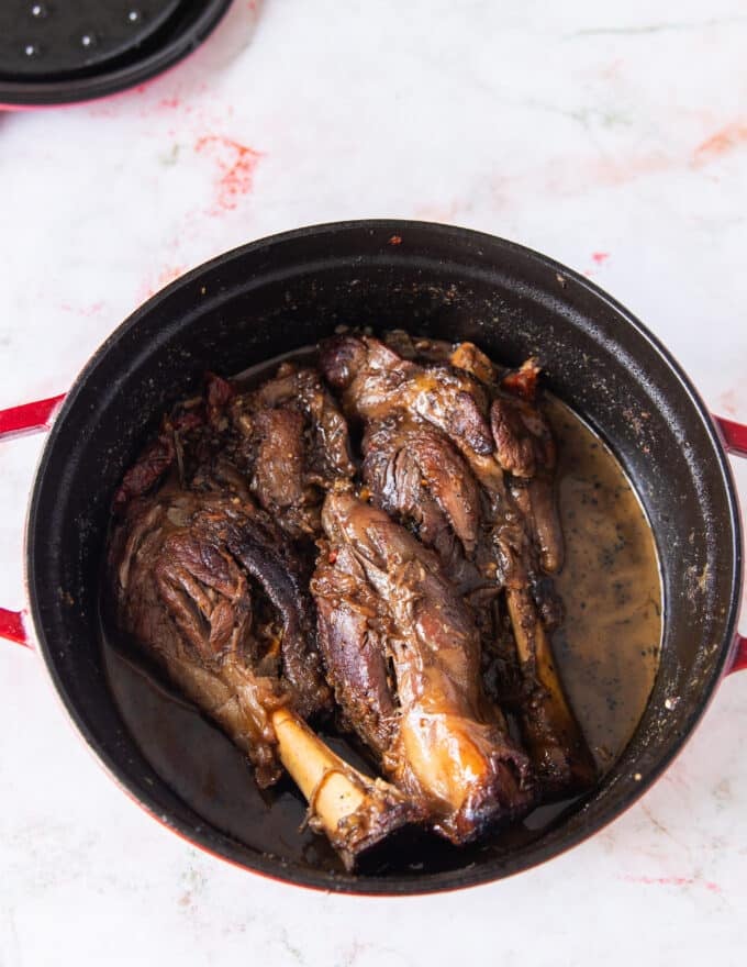 slow cooked lamb shanks that are fork tender and fall off the bone 