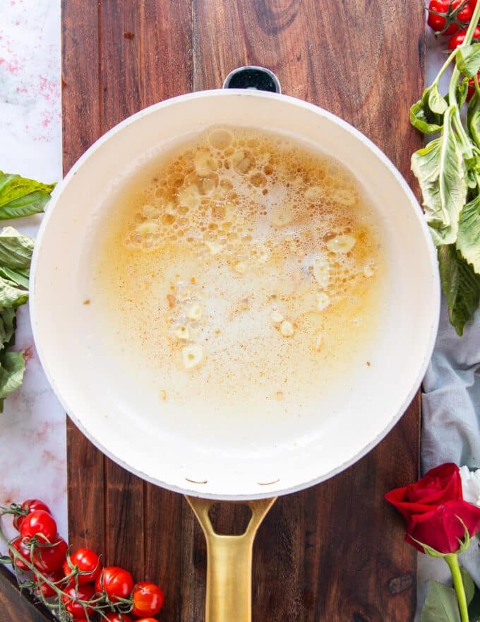 butter and garlic are sautéed in a saucepan to start the sauce