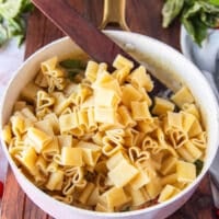 drained and cooked pasta added to the sun dried tomato sauce in the pan