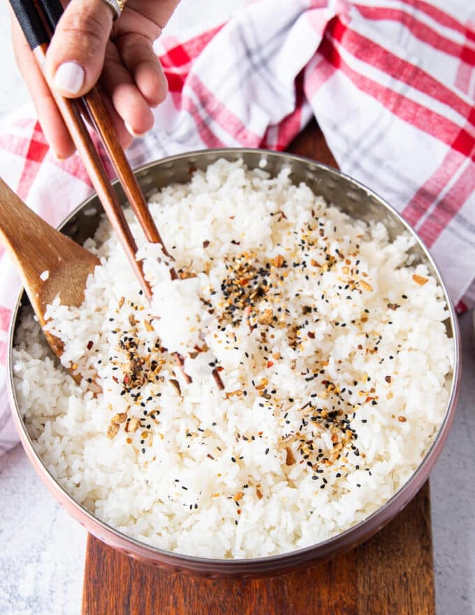 two chopsticks eating sushi rice showing close up of the texture