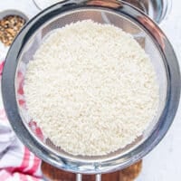 the short grain rice in a sieve ready to be rinsed and soaked