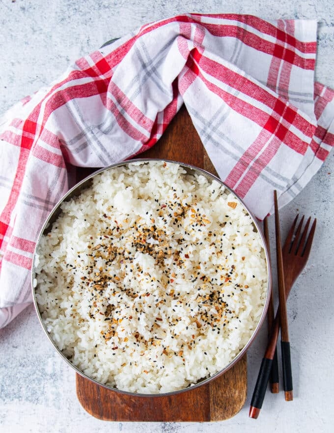 Top view of a bowl of sushi rice with furikake topping and