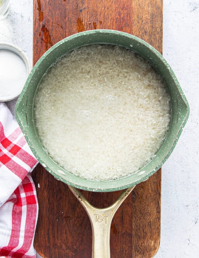 The rice and water placed in a pot ready to cook