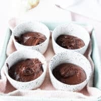 The brownie pudding batter is divided among the dishe