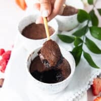 A spoon showing a scoop of the brownie pudding with the crackled tops and fudgy soft inside