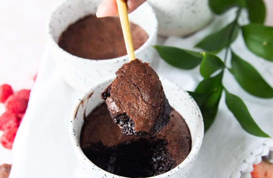 A spoon showing a scoop of the brownie pudding with the crackled tops and fudgy soft inside