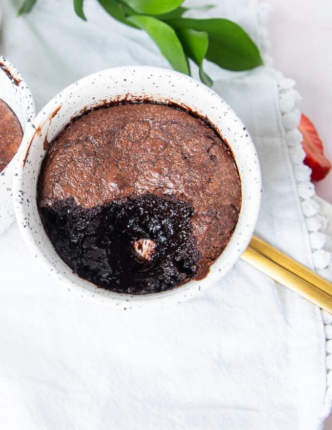close up of a brownie pudding with the spoon taken off showing the contrast in texture with the crackly tops and soft molten centers