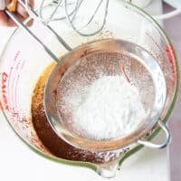 flour now being sifted into the brownie pudding batter