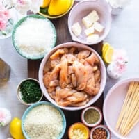Ingredients Needed to make chicken spiedini including small bowls of ingredients on a large table