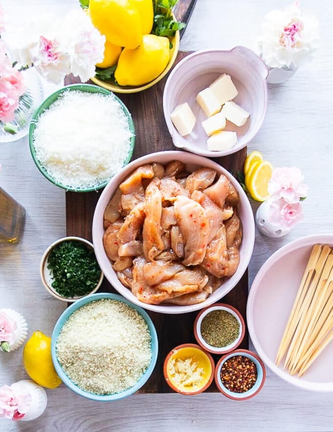 Ingredients Needed to make chicken spiedini including small bowls of ingredients on a large table