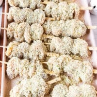 Chicken spiedini skewered on a baking tray and ready to cook