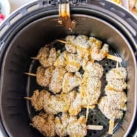 chicken spiedini skewers arranged in an air fryer basket